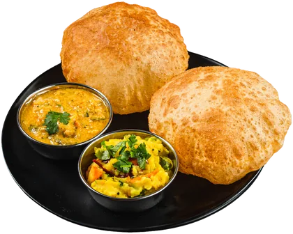 Two puffed poori on a black plate with potato masala and kurma