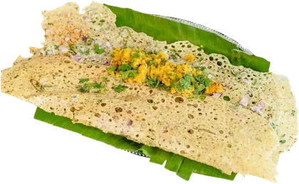 A lacy rava onion dosa on a banana leaf